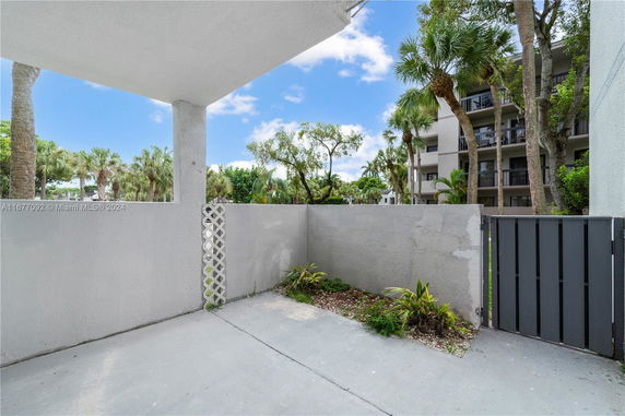 View of surrounding areas with a multi-story building and garden space.