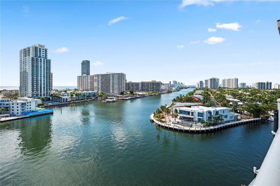 Panoramic view of high-rise buildings and waterfront properties along a canal.