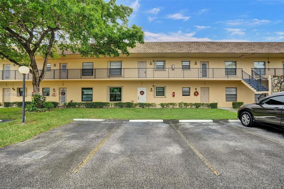 Front view of a two-story apartment building with balconies.