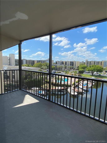View from a balcony overlooking a canal and apartment buildings.