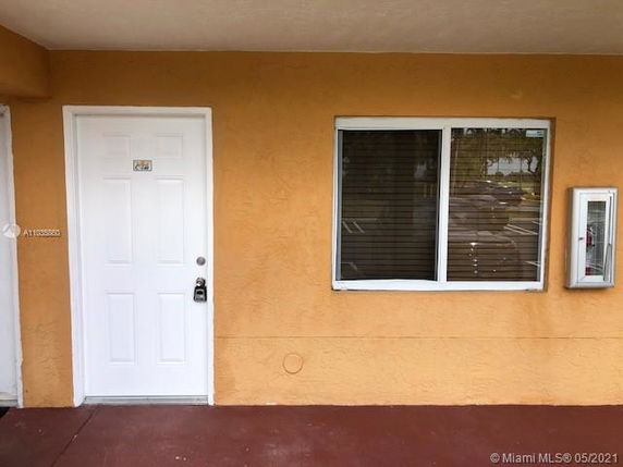 Front view of a building with a door and window