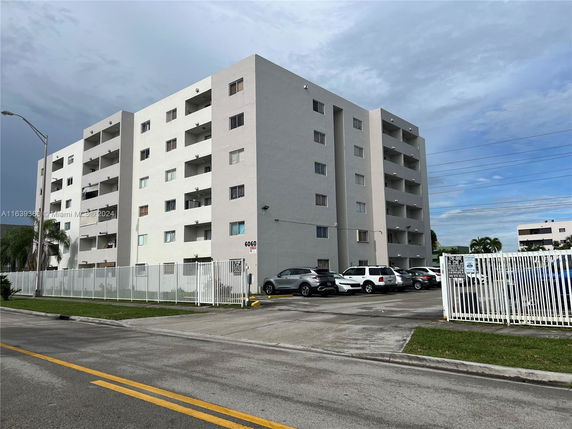 Front view of a multi-story residential building with balconies.