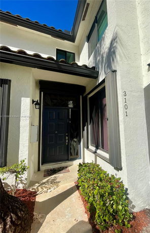 Front view of a house with a black door and windows.