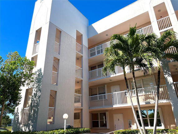 Front view of a multi-story building with balconies.