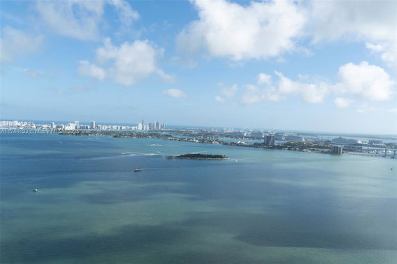 Wide angle view of a coastal city skyline and water bodies.