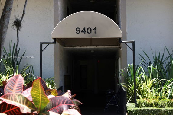 Front view of a building entrance with an overhead canopy displaying the number 9401.