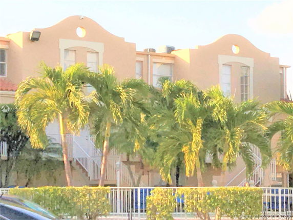 Front view of a two-story building with decorative curved roofline and tall windows.