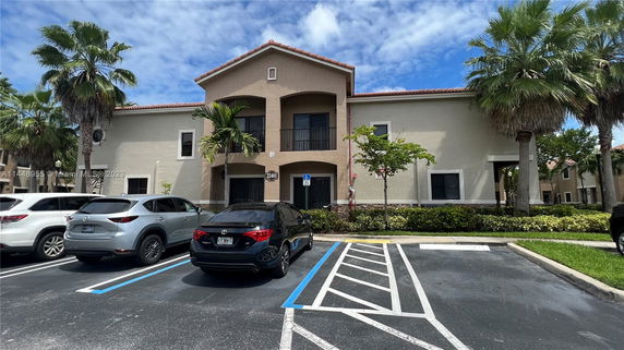 Front view of a two-story building with parking spaces in front.