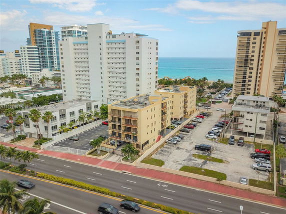 Aerial view of multiple multi-story residential buildings near a coastline