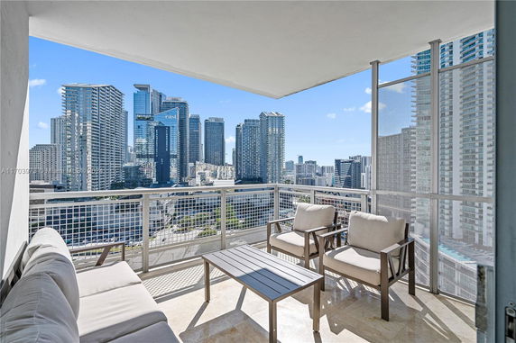 Balcony view overlooking a cityscape with tall skyscrapers in the background.