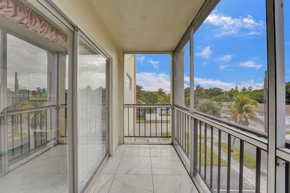 View from a balcony with railings overlooking the surrounding area.