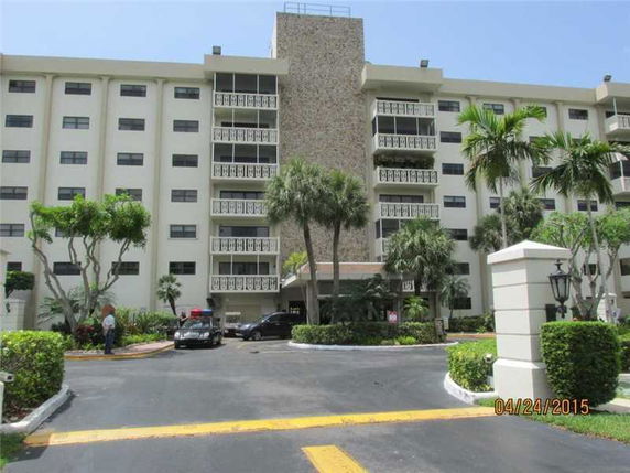 Front view of a multi-story residential building with balconies.