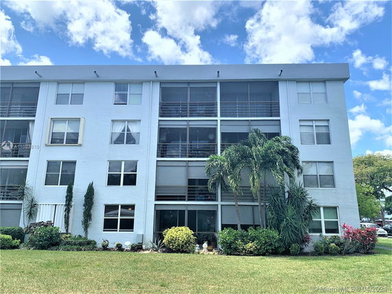 Front view of a multi-story residential building with balconies.