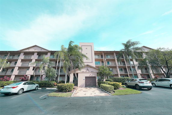 Front view of a multi-story residential building with balconies.