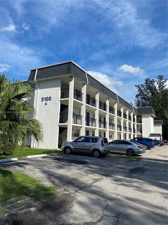 Front view of a multi-story building with balconies.