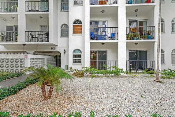 Front view of a multi-story residential building with balconies.