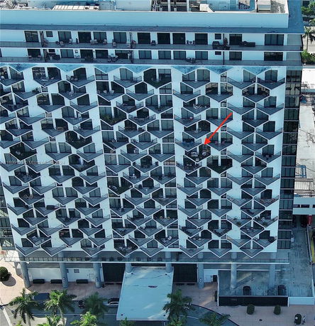 Front view of a multi-story building with a geometric pattern facade.