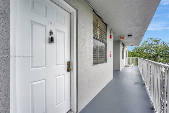 Exterior corridor leading to an apartment door with number 305.