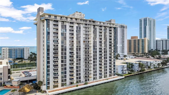 Front view of a high-rise residential building by the water.