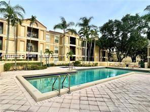 Outdoor swimming pool in front of multi-story residential buildings.