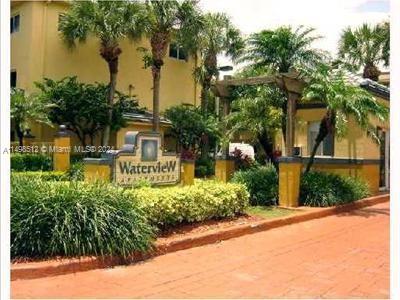 Front view of a building with a sign reading 'Waterview' surrounded by palm trees and greenery.