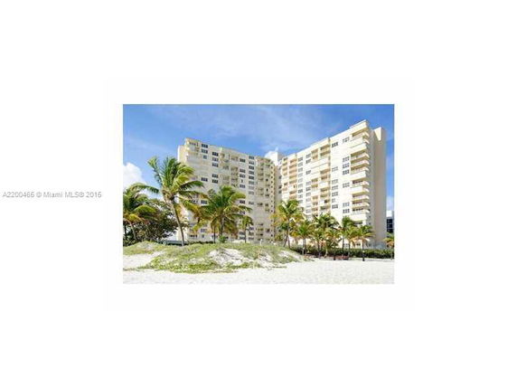 Front view of a multi-story beachfront apartment building.