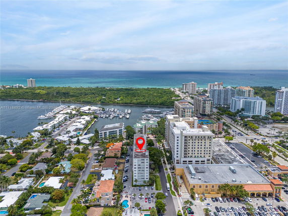 Panoramic view of a coastal cityscape with buildings and a marina.