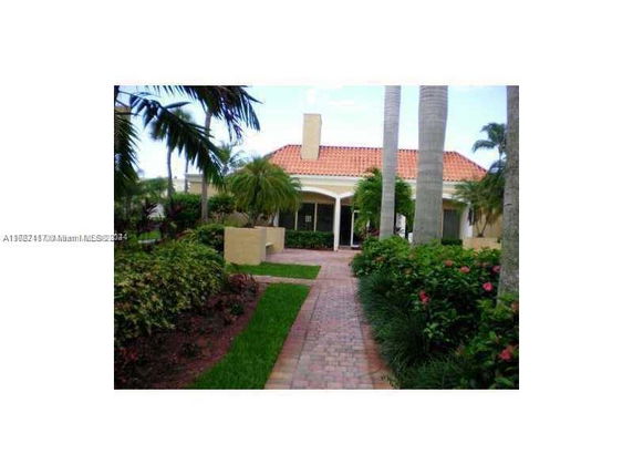Front view of a house with a tiled roof and chimney.