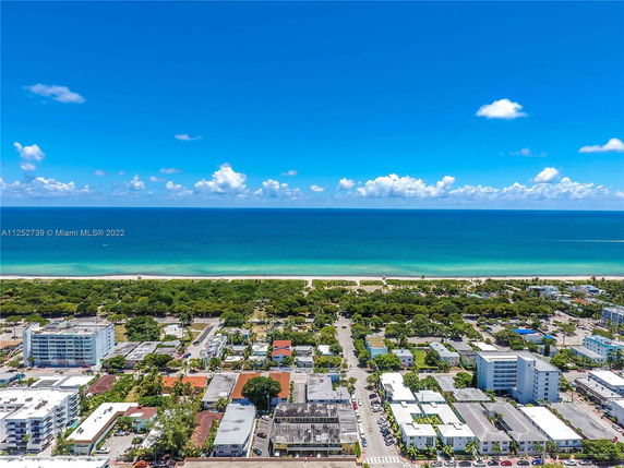 Panoramic view of a coastal area with buildings and the ocean in the background.