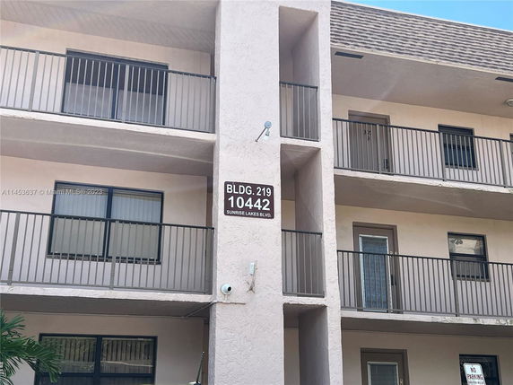 Front view of a multi-story building with balconies.