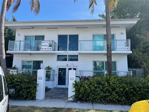 Front view of a two-story building with balconies.