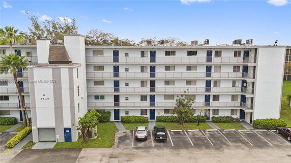Front view of a multi-story building with multiple balconies.