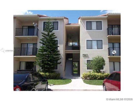 Front view of a multi-story residential building with balconies.