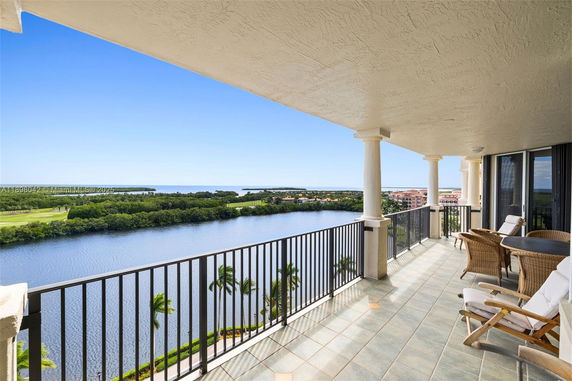 View from a high-rise balcony overlooking a body of water and distant landscape.
