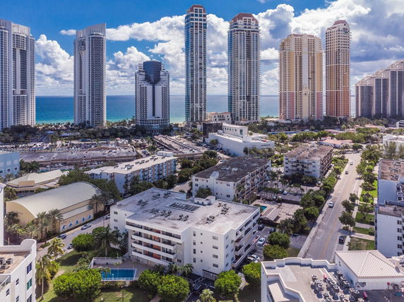 Aerial view of residential and high-rise buildings near the coastline.