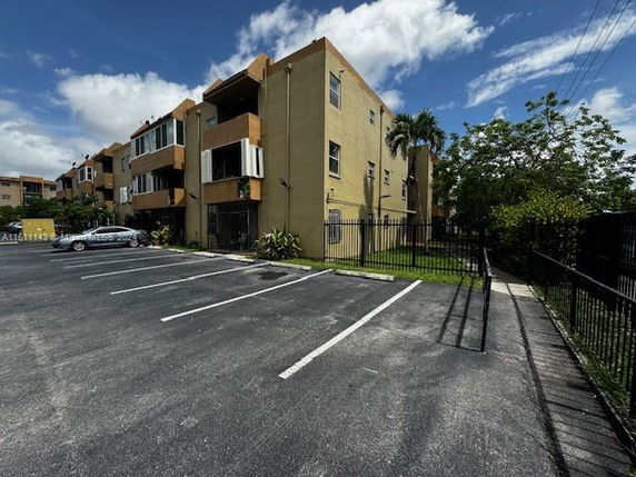 Outdoor parking area adjacent to a multi-story building.