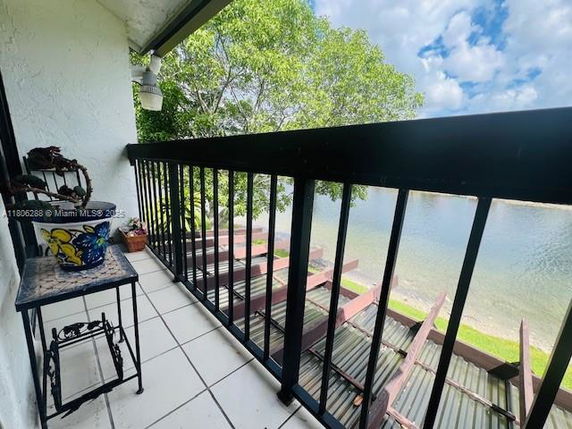 View from a balcony overlooking a body of water and trees.