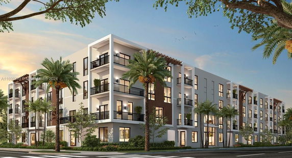 Front view of a multi-story apartment building with balconies and modern design.