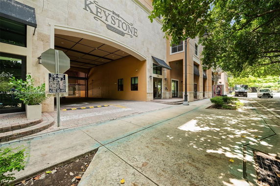 Front view of a building with an archway entrance labeled Keystone Villas.