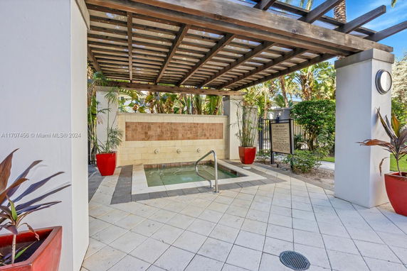 Outdoor spa area with a small pool and a pergola structure.