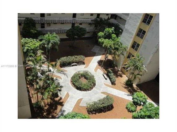 View of a landscaped outdoor courtyard area between buildings.