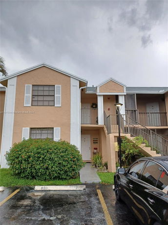 Front view of a two-story residential building with a staircase leading to the upper level.