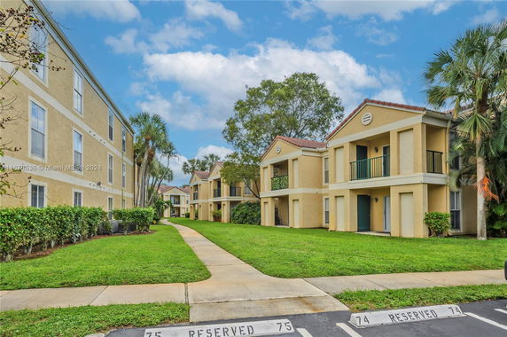 Front view of a multi-story residential building with balconies.