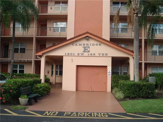 Front view of a multi-story residential building with a garage entrance.