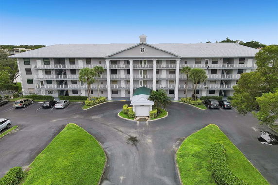 Front view of a multi-story residential building with balconies.
