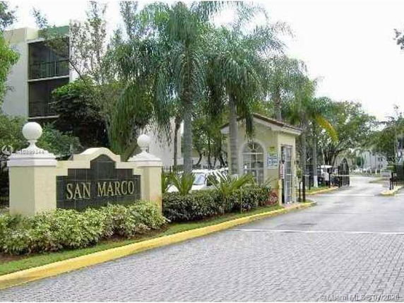 Entrance area of a gated community with a sign reading 'San Marco'.