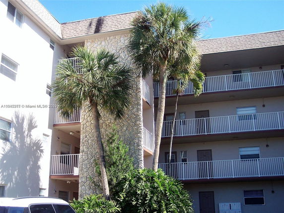 Front view of a multi-story residential building with balconies.