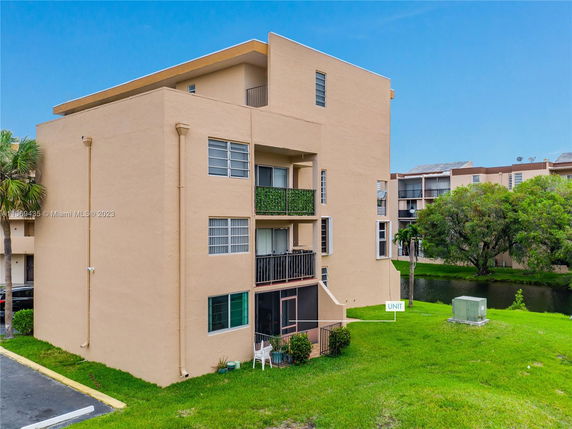 Side view of a multi-story apartment building with balconies.
