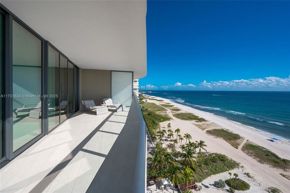 Panoramic view from a balcony overlooking the beach and ocean.