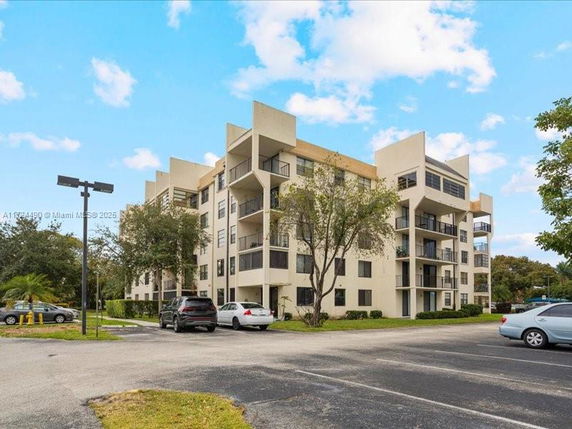 Front view of a multi-story apartment building with multiple balconies.
